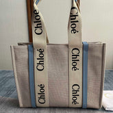 MEDIUM STRAP WOODY TOTE BAG 37 IN BEIGE LINEN CANVAS BLACK WEBBING LOGO EMBROIDER BLUE CALFSKIN