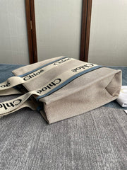 MEDIUM STRAP WOODY TOTE BAG 37 IN BEIGE LINEN CANVAS BLACK WEBBING LOGO EMBROIDER BLUE CALFSKIN