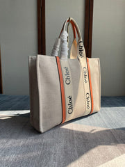 LAGRE WOODY TOTE BAG 45 IN BEIGE LINEN CANVAS BLACK WEBBING LOGO EMBROIDER ORANGE CALFSKIN