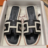 0RAN SANDALS IN BLACK CALFSKIN AND WHITE CANVAS