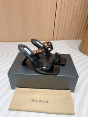 ALAIA TWO-STRAPS HIGH HEEL SANDALS IN BLACK PATENT LAMBSKIN