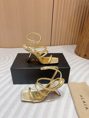 ALAIA THREE-STRAPS HIGH HEEL SANDALS IN GOLDEN PATENT LAMBSKIN