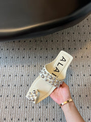 ALAIA FOLDED FLAT MULES WITH SPHERES ON WHITE CALFSKIN