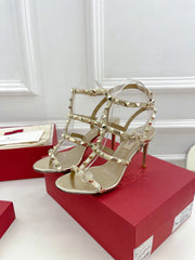 ROCKSTUD 100 GOLD METALLIC CALFSKIN ANKLE STRAP HIGH SANDAL