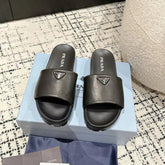 PRADA 25S PADDED SLIDES IN BLACK CALFSKIN WITH LOGO