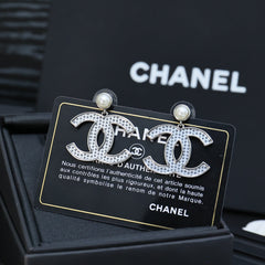 DOUBLE C EARRINGS IN SILVER METAL WITH BLACK SNOWFLAKE EMBOSSED ON WHITE ENAMEL