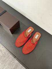 ALAIA FLAT MULES IN CHERRY RED MESH FISHNET