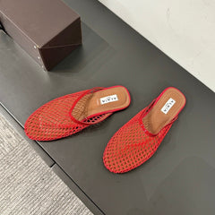 ALAIA FLAT MULES IN CHERRY RED MESH FISHNET