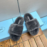 THICK-SOLED FUR SLIDES GRAY WITH TRIANGLE LOGO