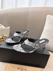 ALAIA HEELED THONG SANDALS 25S 55MM IN WHITE AND BLACK LAMBSKIN SNAKE-EMBOSSED