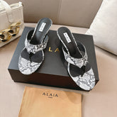 ALAIA HEELED THONG SANDALS 25S 55MM IN WHITE AND BLACK LAMBSKIN SNAKE-EMBOSSED