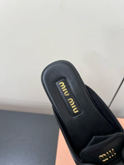 BOW MULES IN BLACK SHEEPSKIN