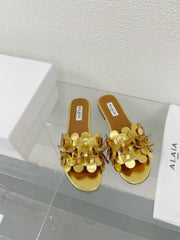 ALAIA FLAT MULE IN GOLDEN GLOSSY LAMBSKIN