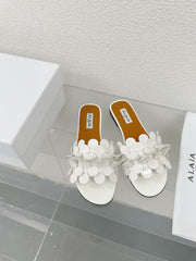 ALAIA FLAT MULE IN WHITE GLOSSY LAMBSKIN