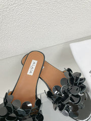 ALAIA FLAT MULE IN BLACK GLOSSY LAMBSKIN