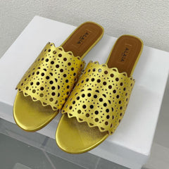 ALAIA VIENNE FLAT MULES IN GOLDEN LAMBSKIN
