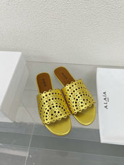 ALAIA VIENNE FLAT MULES IN GOLDEN LAMBSKIN