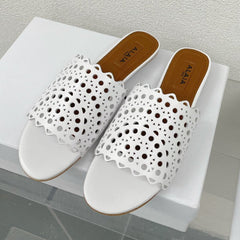 ALAIA VIENNE FLAT MULES IN WHITE LAMBSKIN