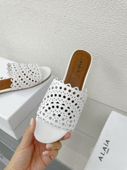 ALAIA VIENNE FLAT MULES IN WHITE LAMBSKIN