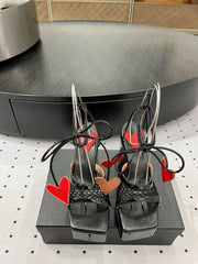 ALAIA BANQUET WEDGE SANDALS IN BLACK LAMBSKIN WITH RED HEART