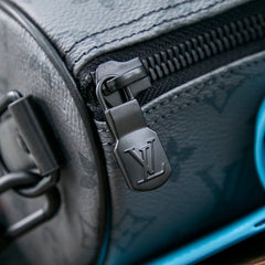 KEEPALL BANDOULIÈRE 25 IN GUN METAL MONOGRAM ECLIPSE CANVAS MIX TURQUOISE CALFSKIN