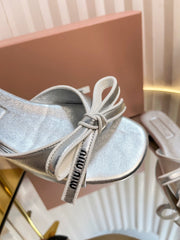 SLIDES SANDALS IN SILVER PATENT CALFSKIN BOW IN TRAP