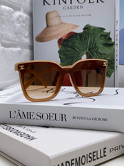 TRIOMPHE SUNGLASSES 552774 IN CARAMEL ACETATE TEXT LOGO