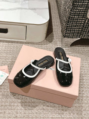 FLAT MULE IN BLACK AND WHITE PATENT CALFSKIN