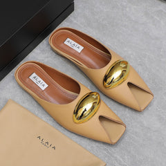 ALAIA FLAT MULE IN SEPIA TAN LAMBSKIN WITH GOLD HARDWARE
