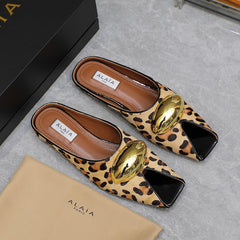 ALAIA FLAT MULE IN LEOPARD LAMBSKIN WITH GOLD HARDWARE