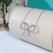 CLAW SET RHODIUM PLATED BOW NECKLACE