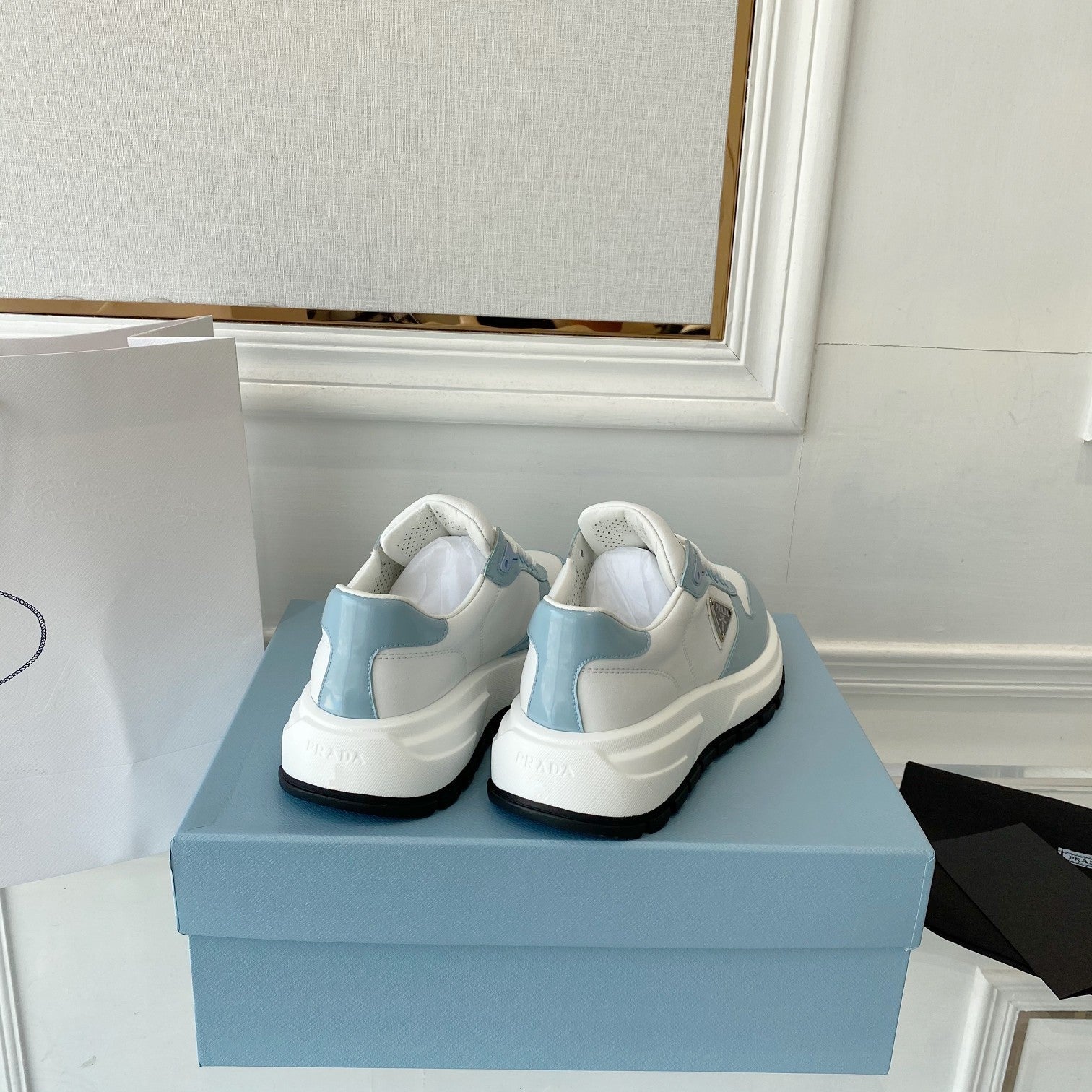 PRADA 25S THICK SOLE SNEAKER IN WHITE AND LIGHT BLUE CALFSKIN