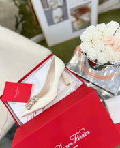 EFFLORESCENCE POINTED-TOE PUMPS IN WHITE SATIN WITH CRYSTAL BUCKLE