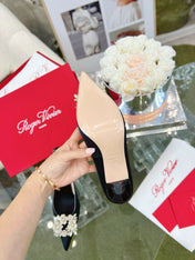 EFFLORESCENCE POINTED-TOE PUMPS IN BLACK SATIN WITH CRYSTAL BUCKLE