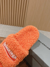 FURRY SLIDES IN ORANGE CURLY SHEARLING