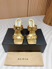 ALAIA TWO-STRAPS HIGH HEEL SANDALS IN GOLDEN PATENT LAMBSKIN