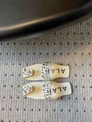 ALAIA FOLDED FLAT MULES WITH SPHERES ON WHITE CALFSKIN