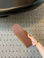 ALAIA FOLDED FLAT MULES WITH SPHERES ON COPPER BROWN CALFSKIN