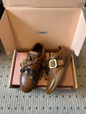 MIUMIU 26S GYMNASIUM SNEAKER IN COGNAC BROWN CALFSKIN WITH GOLD BUCKLED STRAP