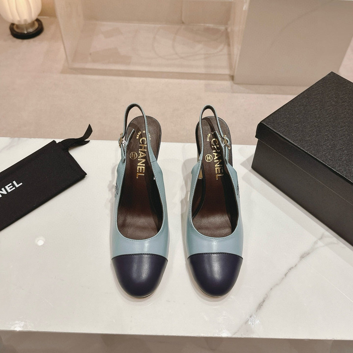CC SLINGBACK PUMPS IN BLUE AND BLACK CALFSKIN