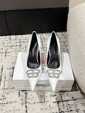 POINTED HIGH PUMPS IN WHITE PATENT CALFSKIN WITH CRYSTAL BUCKLE