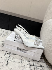 POINTED HIGH SLINGBACK IN WHITE PATENT CALFSKIN WITH CRYSTAL BUCKLE