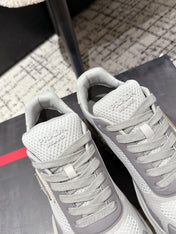 PRADA 25S MEN SNEAKERS IN GRAY AND WHITE CANVAS