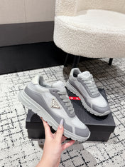 PRADA 25S MEN SNEAKERS IN GRAY AND WHITE CANVAS