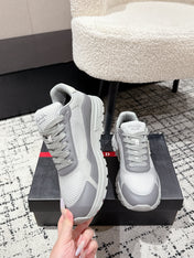 PRADA 25S MEN SNEAKERS IN GRAY AND WHITE CANVAS