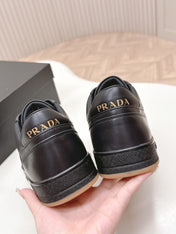 PRADA 25S DOWNTOWN SNEAKERS IN BLACK CALFSKIN