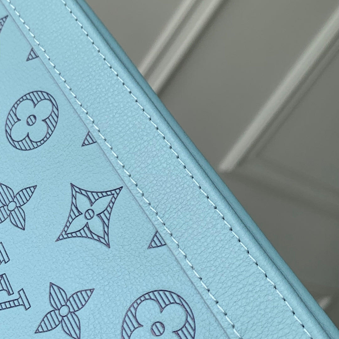 POCHETTE VOYAGE 26 IN SKY BLUE MONOGRAM ECLIPSE CALFSKIN