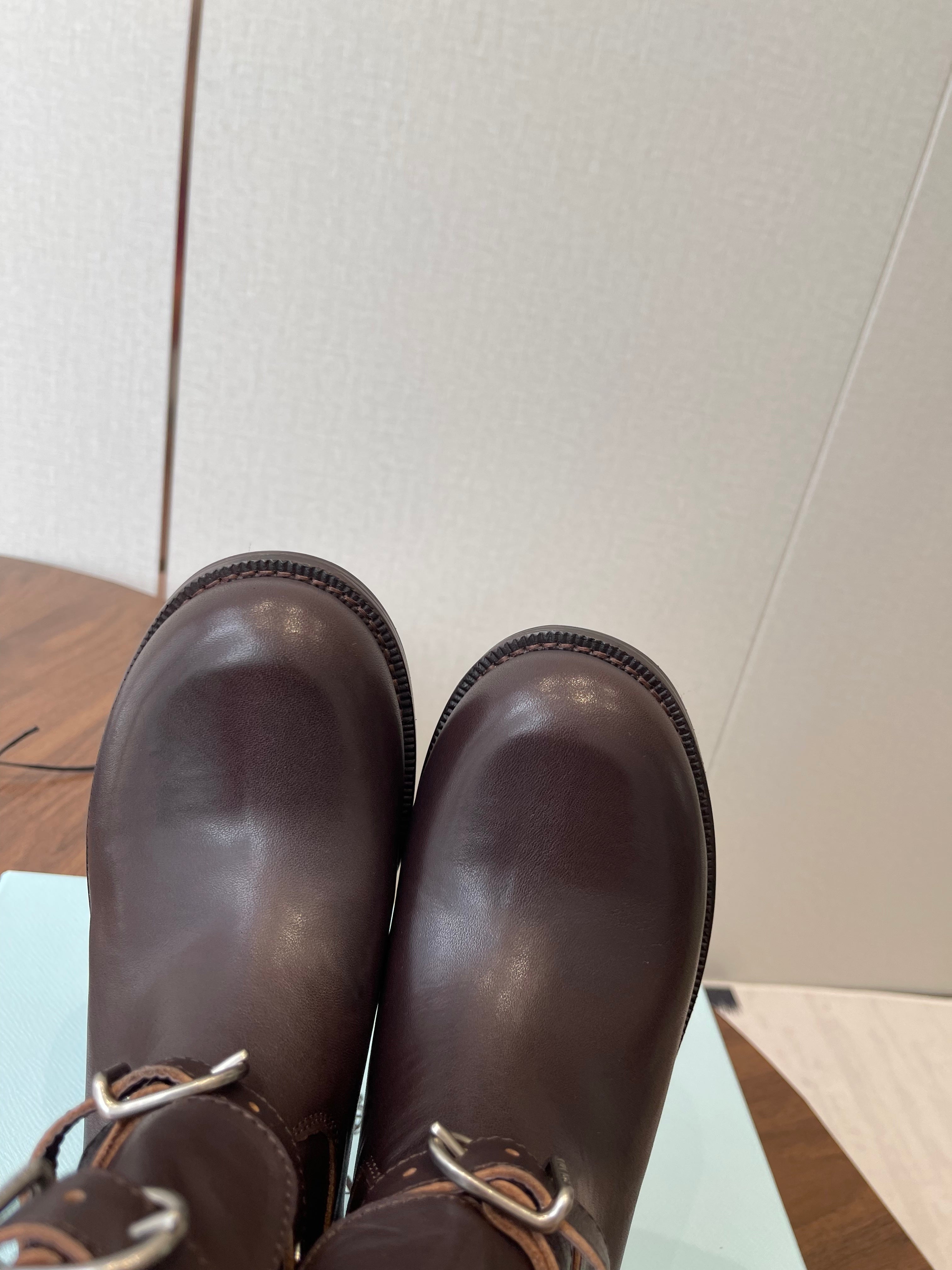 PRADA 25S TWO-BUTTON COWBOY BOOTS IN DARK BROWN CALFSKIN WITH SILVER HARDWARE