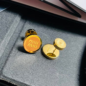 MIUMIU 26S ROUND LOGO STUD EARRINGS IN BROWN ENAMEL AND GOLD TONE METAL 626876