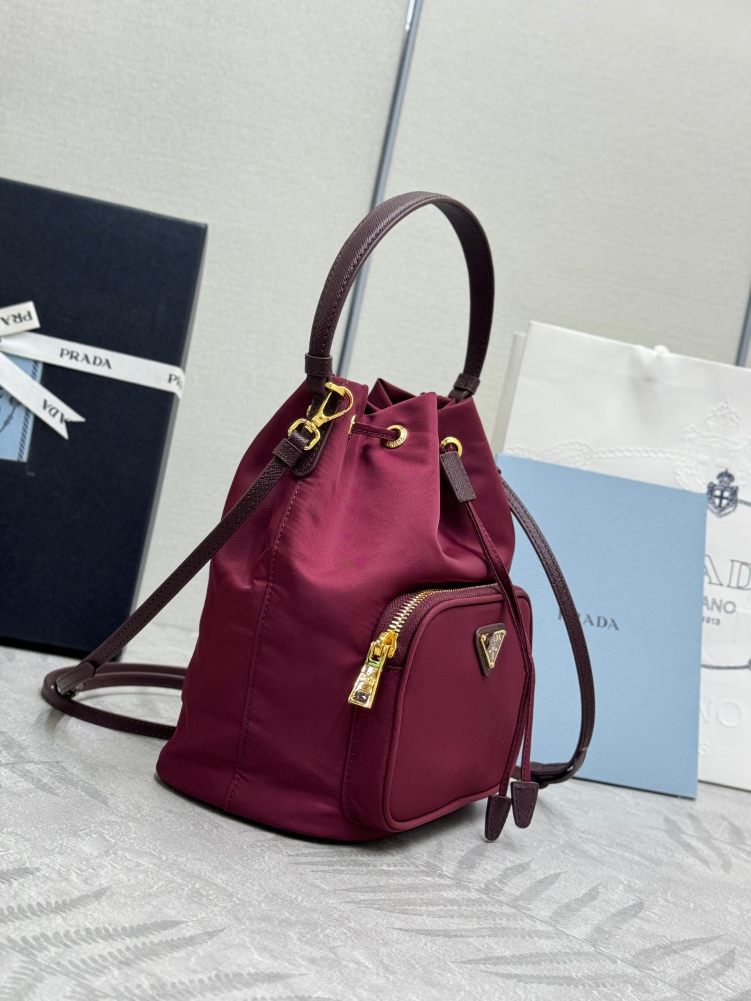 PRADA 25S DUET BUCKET BAG 23 IN BURGUNDY RE-NYLON GOLD HARDWRE
